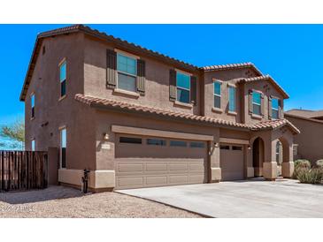 Stunning two-story home featuring a three-car garage and a charming, neutral-toned exterior at 6755 S Tucana Ln, Gilbert, AZ 85298