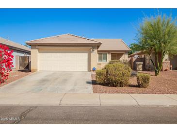 Charming single-story home with a two-car garage and manicured landscaping at 10792 W Elm Ln, Avondale, AZ 85323