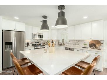 Bright eat-in kitchen featuring a large center island and stainless steel appliances at 14027 N 32Nd St, Phoenix, AZ 85032