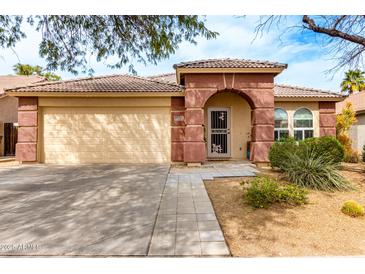 Charming single-story home featuring a two-car garage and a lovely front porch at 17532 W Caribbean Ln, Surprise, AZ 85388