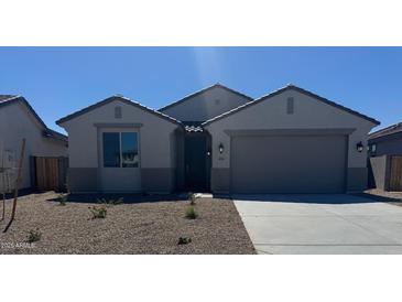 Charming single-story home with low-maintenance landscaping and a two-car garage at 18363 W Monte Lindo Ln, Surprise, AZ 85387