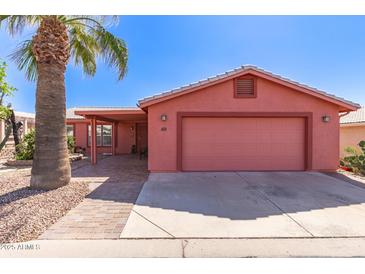 Charming single-story home with a two-car garage, covered porch, and desert landscaping in front at 2101 S Meridian Rd # 60, Apache Junction, AZ 85120