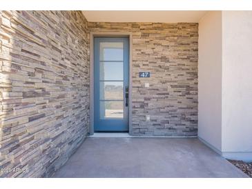 Stylish stone facade frames a modern blue front door with glass panel and house number 47 at 2121 W Sonoran Desert Dr # 47, Phoenix, AZ 85085