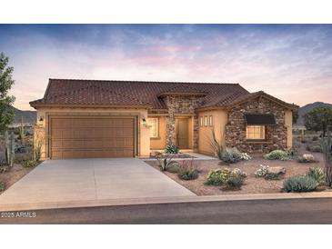 Beautiful single-story home with a two-car garage, desert landscaping, and a mix of stone and stucco exterior at 26650 W Siesta Ln, Buckeye, AZ 85396