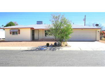 Charming single-story home featuring a two-car garage, desert landscaping, and a welcoming entrance at 5533 E Decatur St, Mesa, AZ 85205