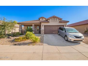 Charming single-story home with a well-manicured desert landscape, covered porch and two car garage at 5625 W Euclid Ave, Laveen, AZ 85339