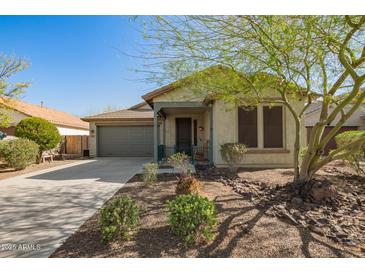 Charming single-story home with a well-maintained front yard and covered porch, featuring a two-car garage at 12711 W Lowden Rd, Peoria, AZ 85383