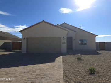 Charming single-story home featuring a well-manicured gravel yard and attached two-car garage at 26409 W Desert Crest St, Casa Grande, AZ 85193