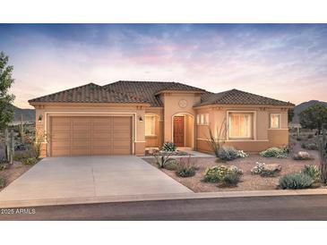 Beautiful single-story home with desert landscaping, a two-car garage, and a tile roof at dusk at 26664 W Siesta Ln, Buckeye, AZ 85396