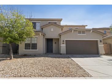 Inviting two-story home with a well-maintained facade, desert landscaping, and an attached two-car garage at 3911 S 100Th Gln, Tolleson, AZ 85353