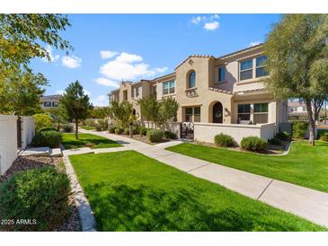 Charming townhome exterior with manicured lawn, walkway, and well-maintained landscaping, creating curb appeal at 4077 S Sabrina Dr # 23, Chandler, AZ 85248