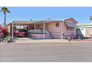 Charming single-level home featuring a covered carport, front porch and landscaped yard at 701 S Dobson Rd # 432, Mesa, AZ 85202