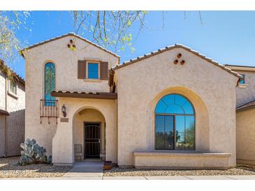 Charming stucco home featuring an arched window and decorative accents at 8429 W Vernon Ave, Phoenix, AZ 85037