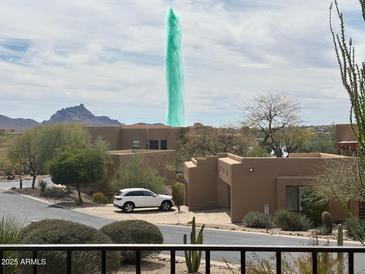 Day view of the community with desert landscaping, fountain and architecture at 13013 N Panorama Dr # 120, Fountain Hills, AZ 85268