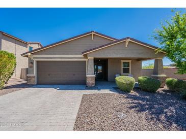 Charming single-story home featuring a well-manicured lawn, desert landscaping, and a two-car garage at 13455 N 142Nd Ave, Surprise, AZ 85379