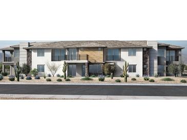 Contemporary townhome showcases stone and stucco facade, a private balcony, and desert landscaping at 2121 W Sonoran Desert Dr # 126, Phoenix, AZ 85085