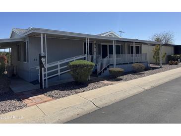 Charming home with covered porch, handicap ramp, and low-maintenance desert landscaping at 2233 E Behrend Dr # 85, Phoenix, AZ 85024
