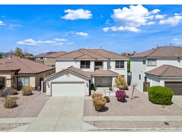 Two-story home with a two-car garage, tiled roof, and well-maintained landscaping at 3144 W Maya Way, Phoenix, AZ 85083