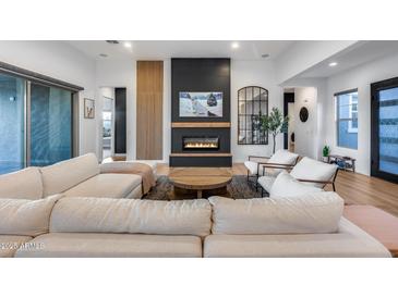 Inviting living room area with comfortable seating, a fireplace, and natural light at 4606 S Ferric --, Mesa, AZ 85212