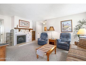 Cozy living room features a fireplace and comfortable seating arrangement at 5525 E Thomas Rd # N5, Phoenix, AZ 85018