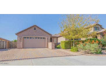 Charming single-story home with a brick-paved driveway and well-manicured landscaping at 560 S 197Th Ave, Buckeye, AZ 85326