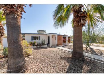 Charming single-story home featuring a desert-friendly landscaped front yard and a quaint patio area at 825 W 12Th St, Tempe, AZ 85281