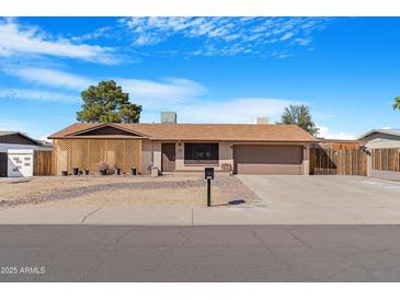 Charming single-story home featuring a two-car garage and low-maintenance landscaping at 1604 W Kerry Ln, Phoenix, AZ 85027