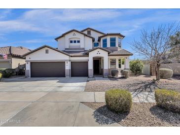 Stunning two-story home with three-car garage, desert landscaping, and charming architectural details at 2417 W Apache Rain Rd, Phoenix, AZ 85085