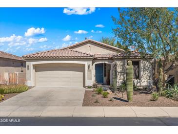 Charming single-story home with a well-manicured front yard and a two car garage at 4542 E Carob Dr, Gilbert, AZ 85298