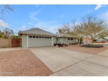 Charming single-story home with tidy front yard, desert landscaping, and two-car garage at 5165 E Tunder Dr, Phoenix, AZ 85044