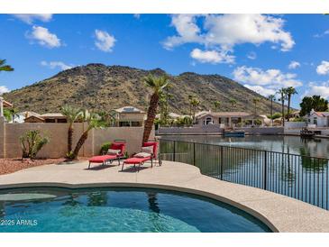 Enjoy a private backyard pool with lake views and mountain scenery at 5471 W Quail Ave, Glendale, AZ 85308