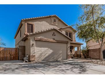 Two story home with a large garage and well-manicured lawn, perfect for suburban living at 7531 W Rock Springs Dr, Peoria, AZ 85383