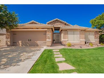 Charming single-story home featuring desert landscaping, stone accents, and a two-car garage at 9420 E Plata Ave, Mesa, AZ 85212