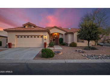 Charming single-story home featuring a tile roof, desert landscaping, and a two-car garage at 15145 W Catalina Dr, Goodyear, AZ 85395