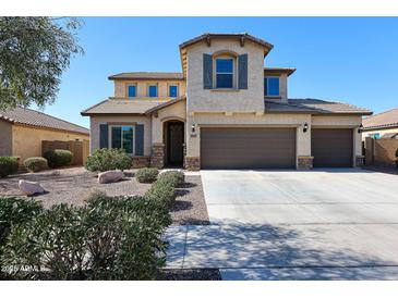 Beautiful two-story home featuring a neutral stucco exterior, 3-car garage, and well-manicured desert landscaping at 17531 W Hedgehog Pl, Surprise, AZ 85387