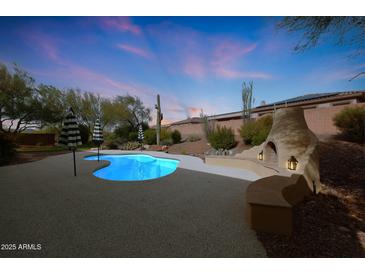 Backyard pool and outdoor fireplace, perfect for evening relaxation and entertainment at 42038 N Moss Springs Rd, Anthem, AZ 85086