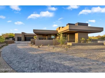 Stunning desert home showcasing modern architecture and meticulous landscape design with paver driveway at 10354 E Celestial Dr, Scottsdale, AZ 85262