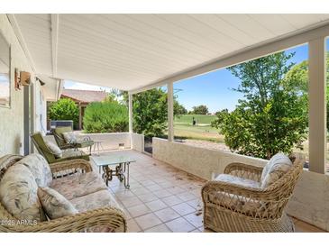 Relaxing covered patio with comfortable seating, overlooking scenic golf course views at 1202 Leisure World --, Mesa, AZ 85206