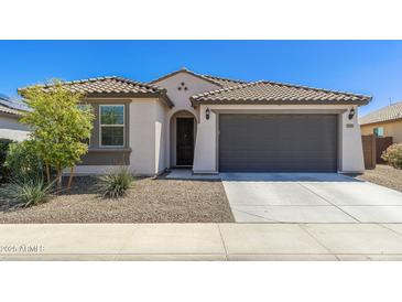 Charming single-story home featuring a tile roof and a spacious two-car garage at 19181 W Jackson St, Buckeye, AZ 85326