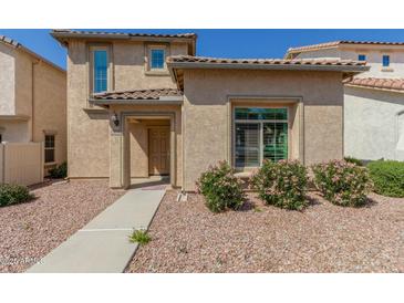 Charming single-Gathering home featuring desert landscaping, a tile roof, and a covered entry at 1926 W Busoni Pl, Phoenix, AZ 85023