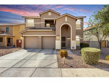 Two-story home featuring a three car garage, arched entryway, neutral color palette, and manicured landscaping at 3535 E Crescent Way, Gilbert, AZ 85298