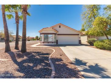 Charming single-story home with a well-manicured front yard and a two-car garage at 39894 N Fazio Ln, San Tan Valley, AZ 85140
