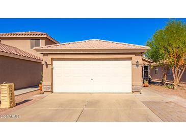 Attached two-car garage showcasing a clean, neutral door and well-maintained exterior in a sunny neighborhood at 11226 W Glenrosa Ave, Phoenix, AZ 85037