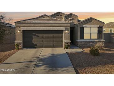 Charming single-Gathering home featuring desert landscaping and a two-car garage at 25634 W Samantha Way, Buckeye, AZ 85326