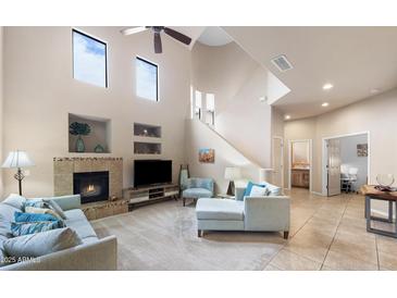 Bright living room featuring a fireplace, high ceilings, and comfortable seating at 3131 E Legacy Dr # 1107, Phoenix, AZ 85042