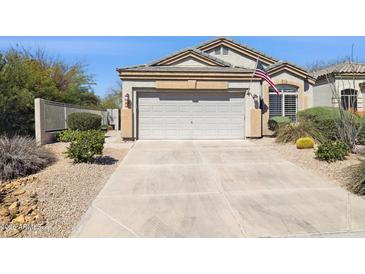 Charming home exterior featuring a spacious two-car garage and well-maintained desert landscaping at 4308 E Smokehouse Trl, Cave Creek, AZ 85331