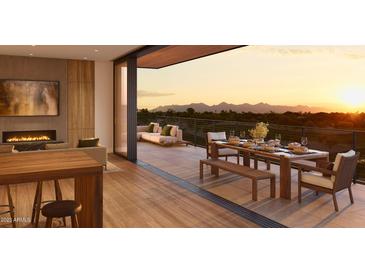 Spacious patio with comfortable seating and dining area offering stunning mountain views at sunset at 4849 N Camelback Ridge Rd # A106, Scottsdale, AZ 85251