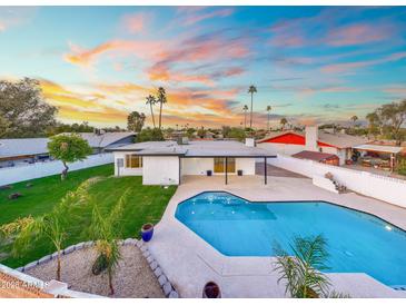 Inviting backyard pool and lush landscaping offers a serene outdoor living space at 1317 E Verlea Dr, Tempe, AZ 85282