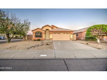 Charming single-story home with a well-maintained desert landscape and inviting curb appeal at 15443 N 86Th Ln, Peoria, AZ 85382
