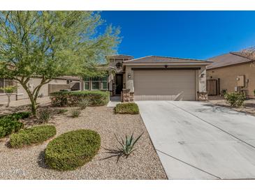 Charming single-story home with a two-car garage, desert landscaping, and a welcoming front entrance at 17784 W Sandy Rd, Goodyear, AZ 85338